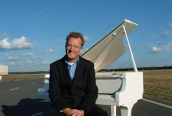 Howard Goodall at a white grand piano